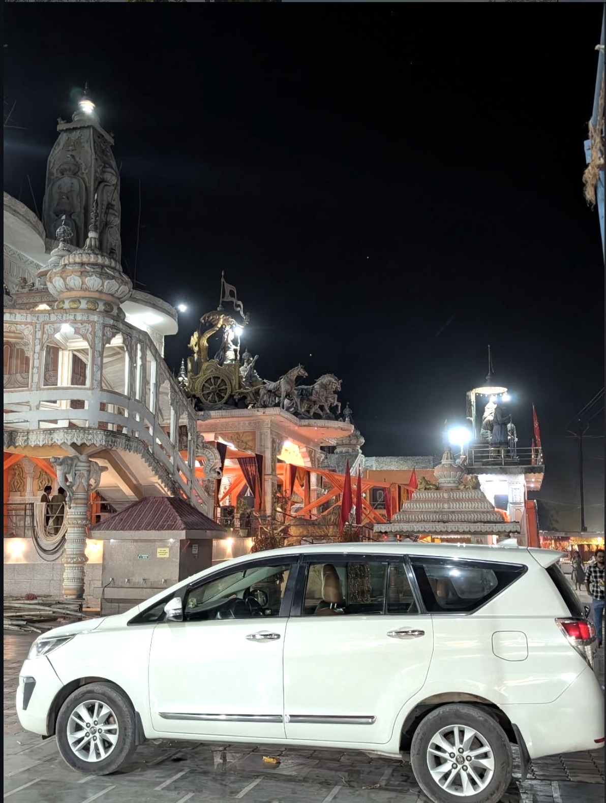 Namastey Travels car outside a temple at night